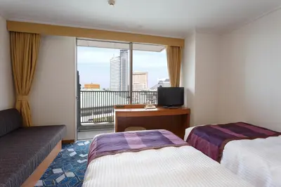 a hotel room with two beds and a balcony at Ryogoku View Hotel in Tokyo