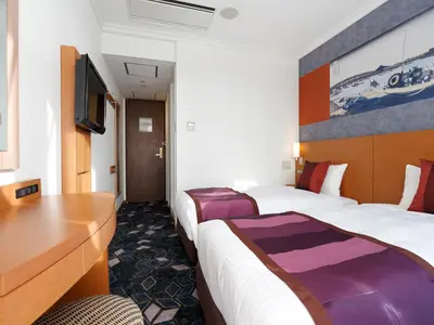 a hotel room with two beds and a desk at Ryogoku View Hotel in Tokyo