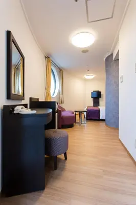 a hotel room with a bedroom and a living room at Ryogoku View Hotel in Tokyo