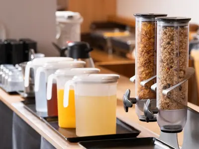 a row of jars of food and drinks on a counter at APA Hotel Higashi Shinjuku Kabukicho in Tokyo