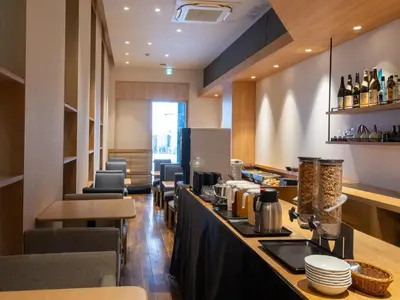 a restaurant with a bar and some chairs at APA Hotel Higashi Shinjuku Kabukicho in Tokyo