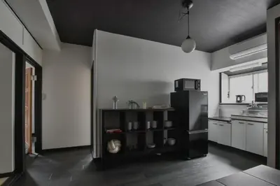 a kitchen with a black refrigerator and a counter at Okada Building - Vacation STAY 16358 in Tokyo