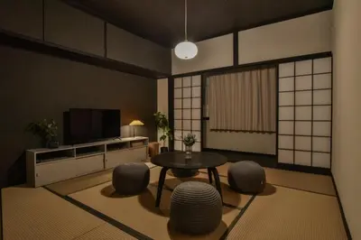 a living room with a table and chairs and a tv at Okada Building - Vacation STAY 16358 in Tokyo