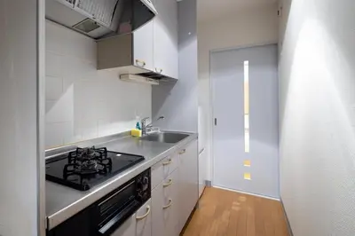 a small kitchen with a stove and a sink at \u30b7\u30e3\u30eb\u30de\u30f3\u3084\u3088\u3044 in Tokyo