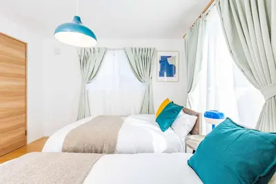 a bedroom with two beds and a window at Modern House Tokyo east in Tokyo