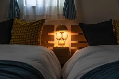 a bedroom with two beds and a lamp on a night stand at Modern House Tokyo east in Tokyo