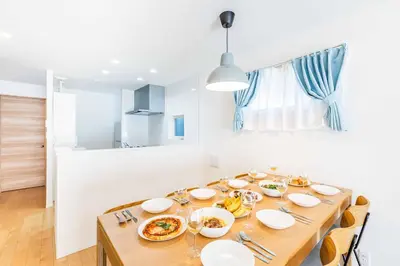 a dining room table with plates of food on it at Modern House Tokyo east in Tokyo