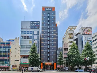 a tall building in the middle of a city at APA Hotel AkihabaraSuehirocho Ekimae -Electric Town- in Tokyo