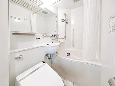 a white bathroom with a toilet and a sink at APA Hotel AkihabaraSuehirocho Ekimae -Electric Town- in Tokyo