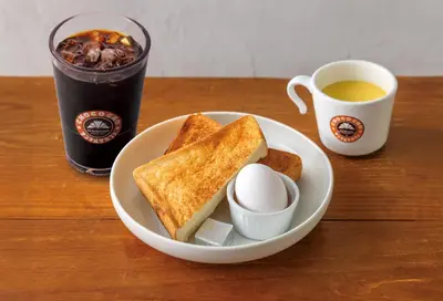 a plate of toast and a cup of coffee and a drink at Sotetsu Fresa Inn Ochanomizu Jimbocho in Tokyo
