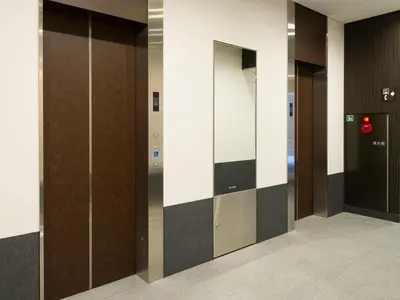 a row of elevator doors in a building at Sotetsu Fresa Inn Ochanomizu Jimbocho in Tokyo