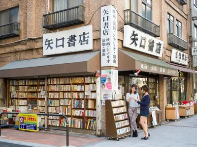 two people standing in front of a book store at Sotetsu Fresa Inn Ochanomizu Jimbocho in Tokyo