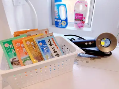 a basket filled with books and a pair of scissors at \u5409\u5c4b in Tokyo