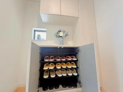 a small refrigerator with a bunch of shoes in it at \u5409\u5c4b in Tokyo