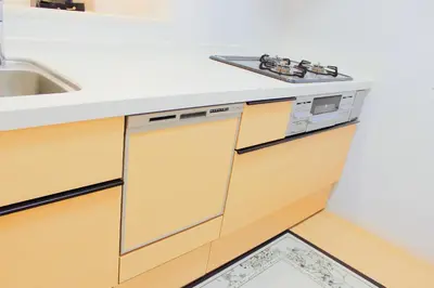 a kitchen with wooden cabinets and a sink at \u5409\u5c4b in Tokyo