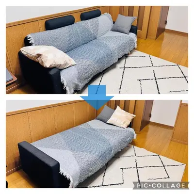 a couch in a living room with a blue blanket at Sui HOUSE \u5317\u8d64\u7fbd in Tokyo