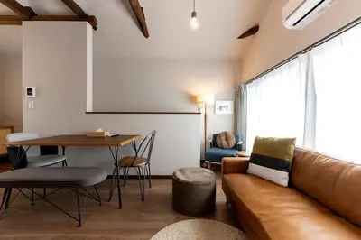 a living room with a couch and a table at \u30d9\u30eb\u30d3\u30e5\u30fc\u516b\u5e83 in Tokyo