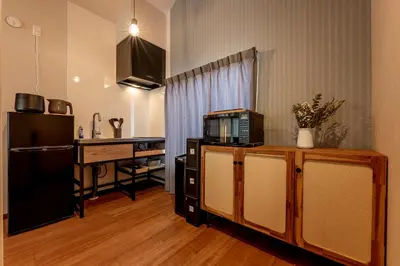 a kitchen with a counter top and a microwave at \u30d9\u30eb\u30d3\u30e5\u30fc\u516b\u5e83 in Tokyo