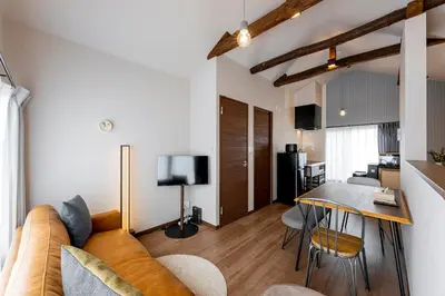 a living room with a couch and a table at \u30d9\u30eb\u30d3\u30e5\u30fc\u516b\u5e83 in Tokyo