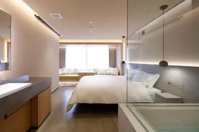 a bedroom with a bed with a glass wall at HotelCO Kuramae \u30db\u30c6\u30eb \u30b3 \u8535\u524d in Tokyo