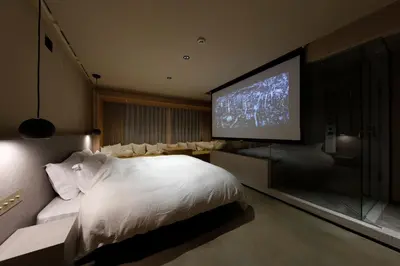 a bedroom with a large bed and a flat screen tv at HotelCO Kuramae \u30db\u30c6\u30eb \u30b3 \u8535\u524d in Tokyo