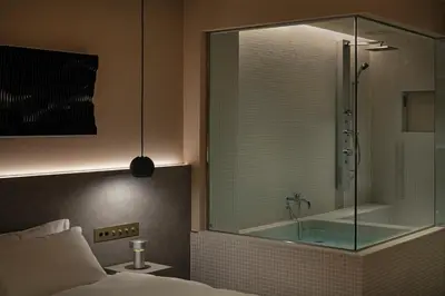 a bedroom with a glass shower and a bed at HotelCO Kuramae \u30db\u30c6\u30eb \u30b3 \u8535\u524d in Tokyo