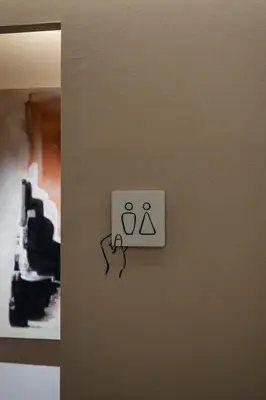 a lightswitch on a wall with a sign on it at HotelCO Kuramae \u30db\u30c6\u30eb \u30b3 \u8535\u524d in Tokyo