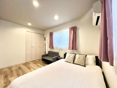 a bedroom with a white bed and a chair at Ichigayayanagichō 牛込柳町一户建-SJ0186 in Tokyo
