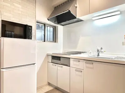 a white kitchen with a sink and a microwave at Ichigayayanagichō 牛込柳町一户建-SJ0186 in Tokyo