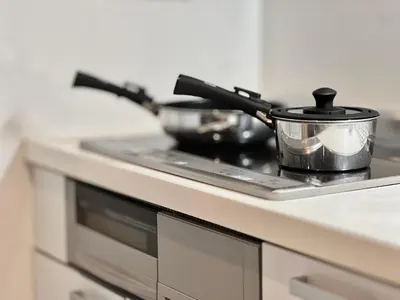 a stove top with a pot and pans on it at Ichigayayanagichō 牛込柳町一户建-SJ0186 in Tokyo