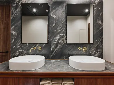 a bathroom with two sinks and a mirror at illi Enu Yotsuya in Tokyo