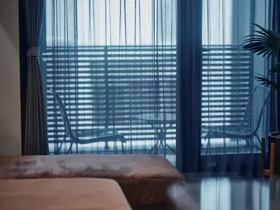 a bedroom with a large window with a view of a building at illi Enu Yotsuya in Tokyo