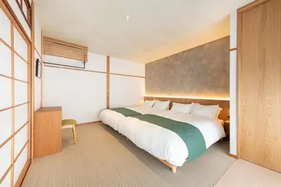 a bedroom with a large bed and a window at TOsuiKYO in Tokyo