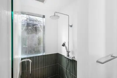 a bathroom with a shower with a glass door at TOsuiKYO in Tokyo