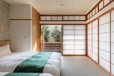 a bedroom with a bed and a large window at TOsuiKYO in Tokyo