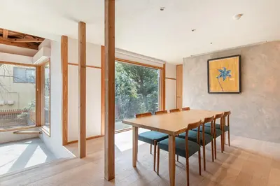 a dining room with a wooden table and chairs at TOsuiKYO in Tokyo