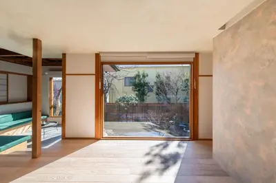 a pivot door in a room with a view of a yard at TOsuiKYO in Tokyo