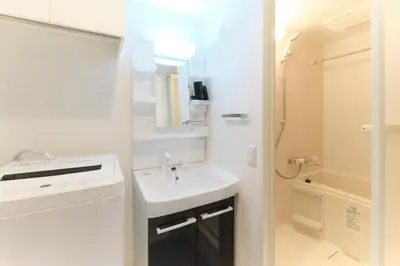 a white bathroom with a sink and a shower at Hotel Dieu Nakanobu by Tranova in Tokyo