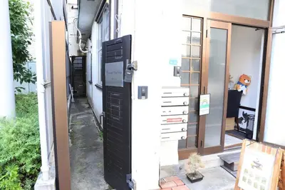an entrance to a house with a black door at 8路線使用可能！アクセス抜群/池袋駅より徒歩5分/最大11名/Wi-Fi完備/まるごと3LDK in Tokyo
