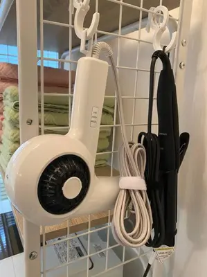 a hair dryer is hanging on a wall at 8路線使用可能！アクセス抜群/池袋駅より徒歩5分/最大11名/Wi-Fi完備/まるごと3LDK in Tokyo