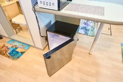 a drawer under a desk with a drawer under a table at Van Gogh Tokyo Shinjyuku Shibuya New Open ! in Tokyo