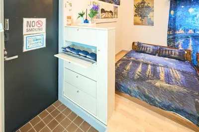 a bedroom with a bed and a dresser at Van Gogh Tokyo Shinjyuku Shibuya New Open ! in Tokyo