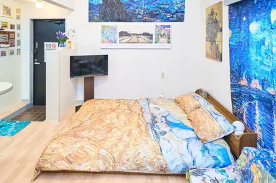 a bedroom with a bed and a flat screen tv at Van Gogh Tokyo Shinjyuku Shibuya New Open ! in Tokyo