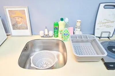 a bathroom counter with a sink and cleaning products at Van Gogh Tokyo Shinjyuku Shibuya New Open ! in Tokyo