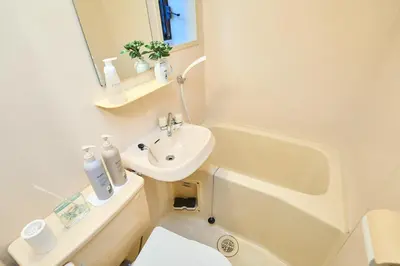 a white bathroom with a sink and a tub and a toilet at Van Gogh Tokyo Shinjyuku Shibuya New Open ! in Tokyo