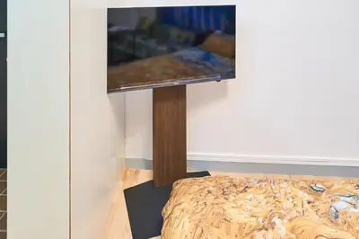 a tv on a stand in the corner of a room at Van Gogh Tokyo Shinjyuku Shibuya New Open ! in Tokyo