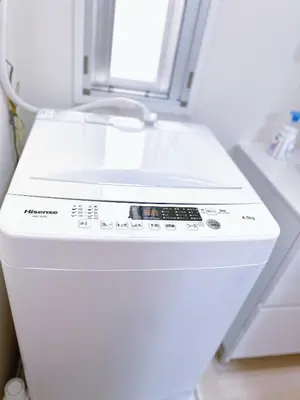 a white washing machine in a room with a window at Base36 in Tokyo