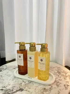 three bottles of honey on a plate on a table at Base36 in Tokyo