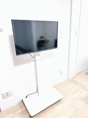 a flat screen tv on a white stand in a room at Base36 in Tokyo