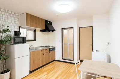 a kitchen with a white refrigerator and a table at Liberty Corp 101 - Vacation STAY 16233 in Tokyo